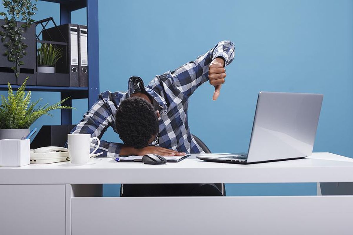 Distressed man working on a project on his laptop