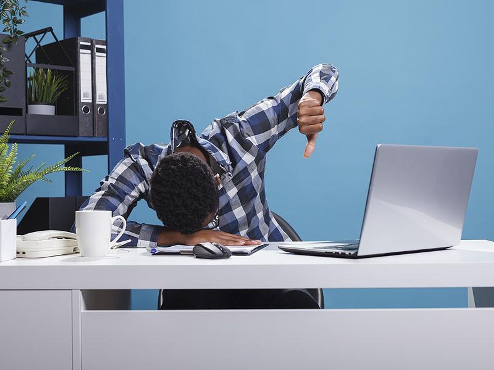 Distressed man working on a project on his laptop