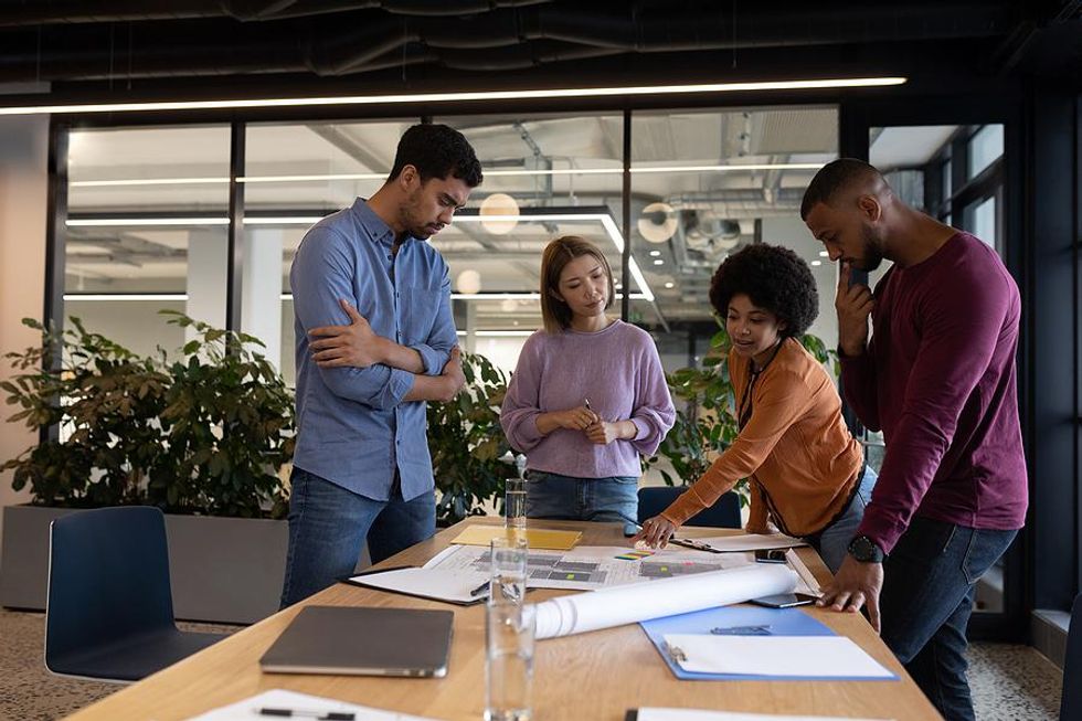 Diverse coworkers/employees work on a project together in an inclusive workplace