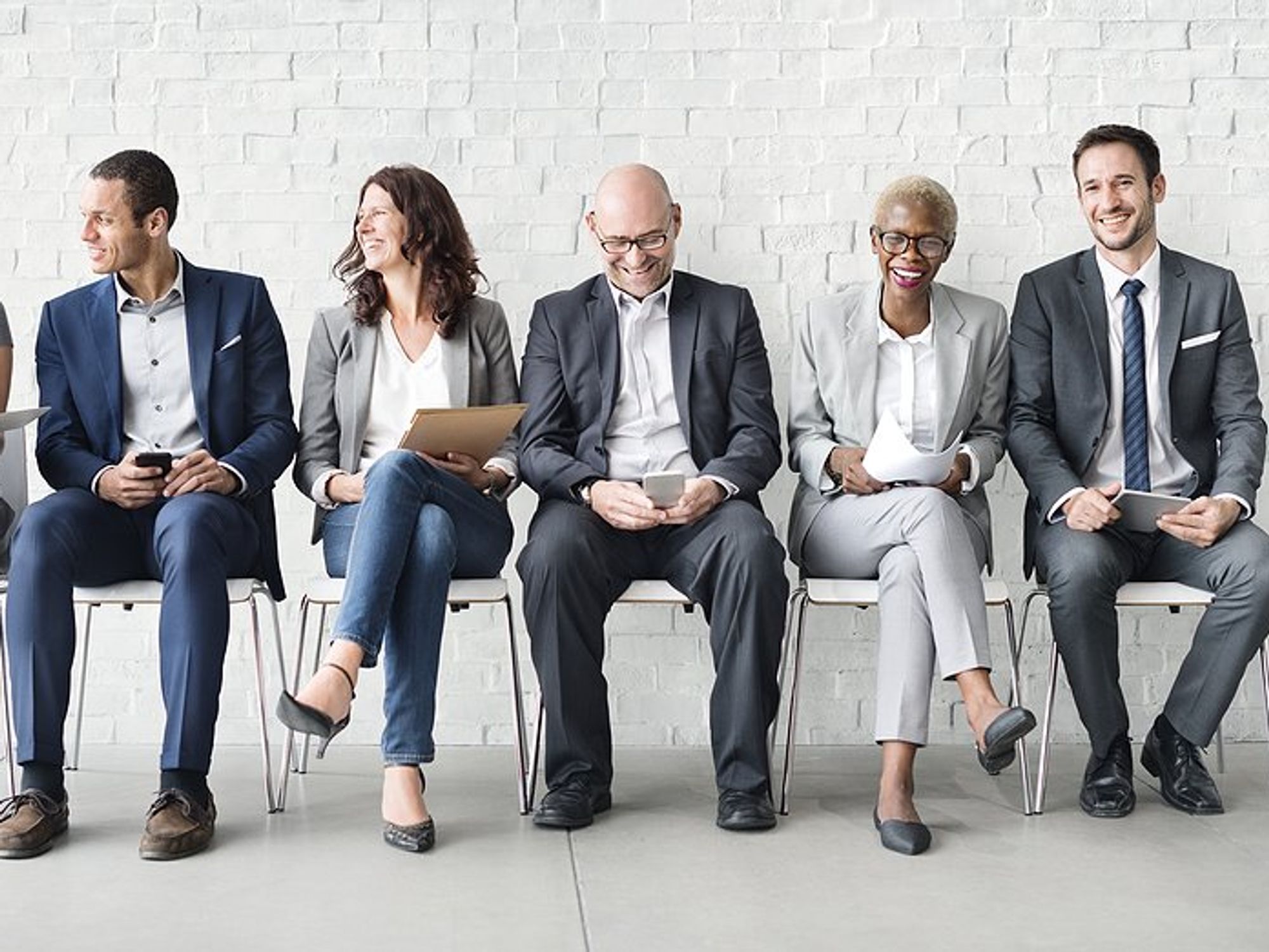 Diverse job candidates wait for an interview