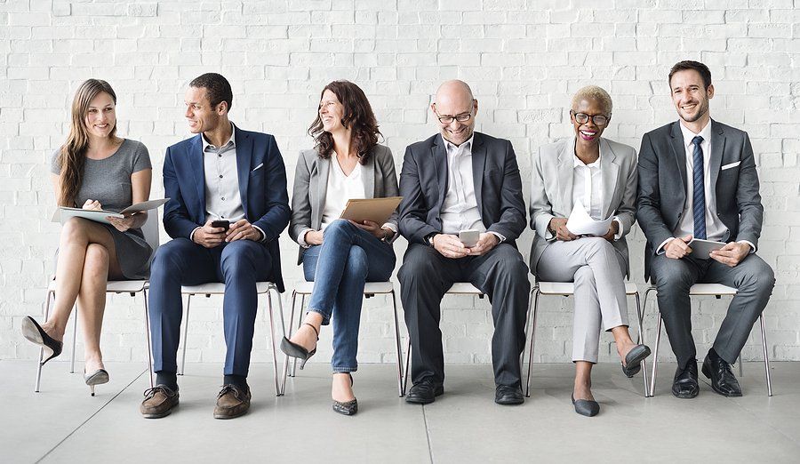 Diverse job candidates wait for an interview