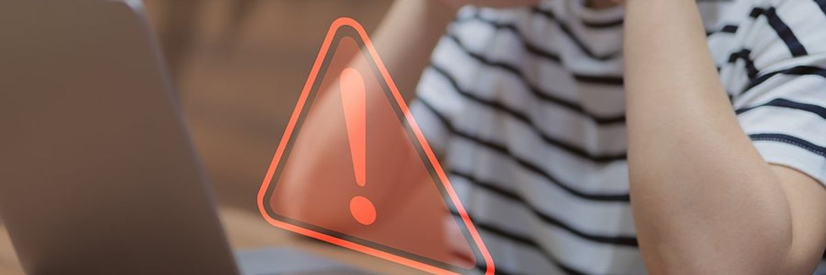 Employee on laptop realizes their company's IT operations are failing