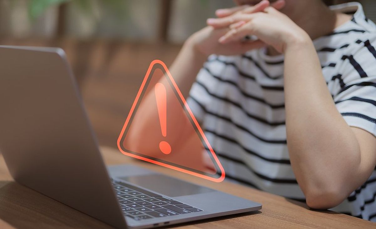 Employee on laptop realizes their company's IT operations are failing