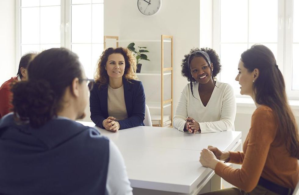 Employees attend a team meeting