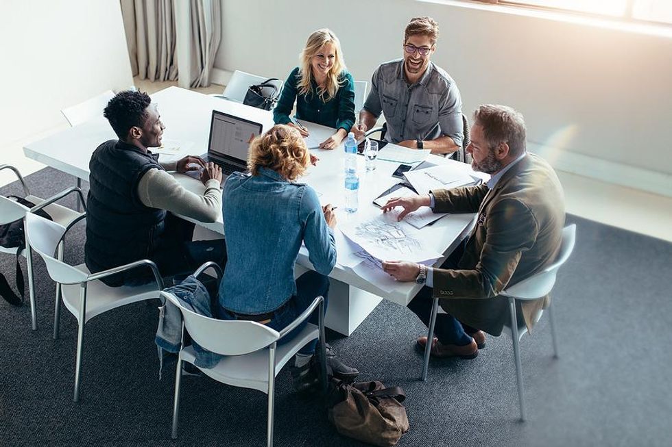 Employees have a project kickoff meeting