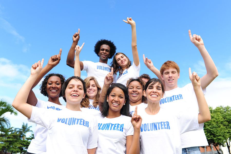 Employees pose for a photo after taking part in a workplace community service project