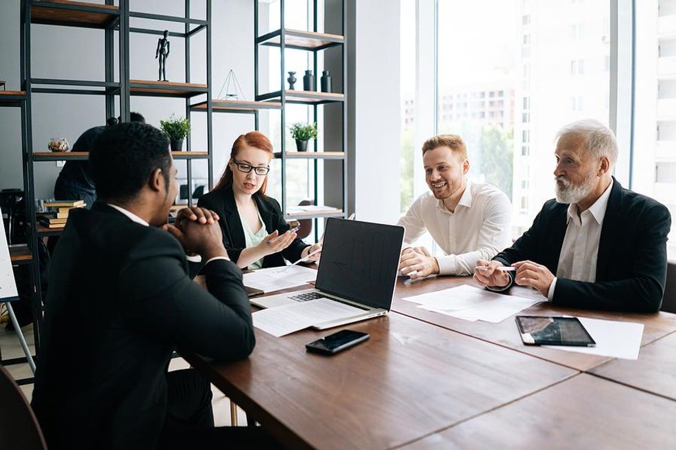 Employees talk during a work meeting