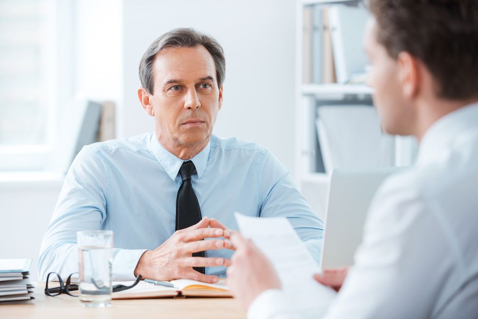 Employer asking a job candidate interview questions to find out more about him