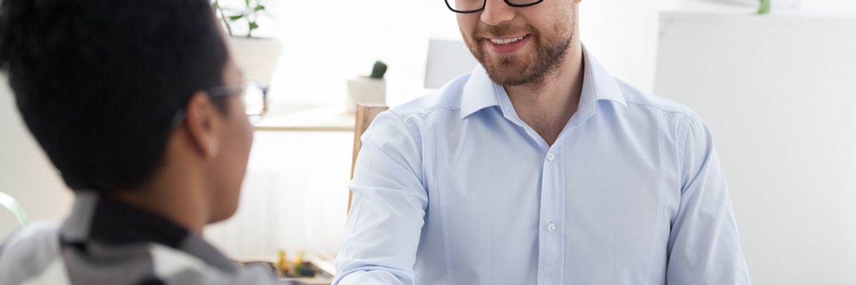 Employer shakes hands with an ideal job candidate after an interview