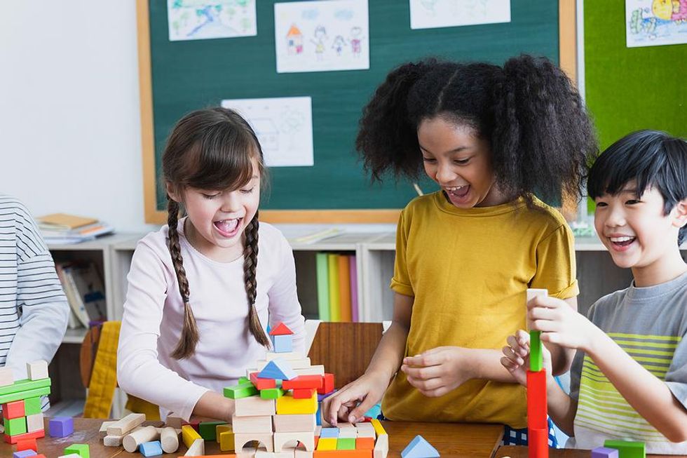 Engaged students play with blocks during class