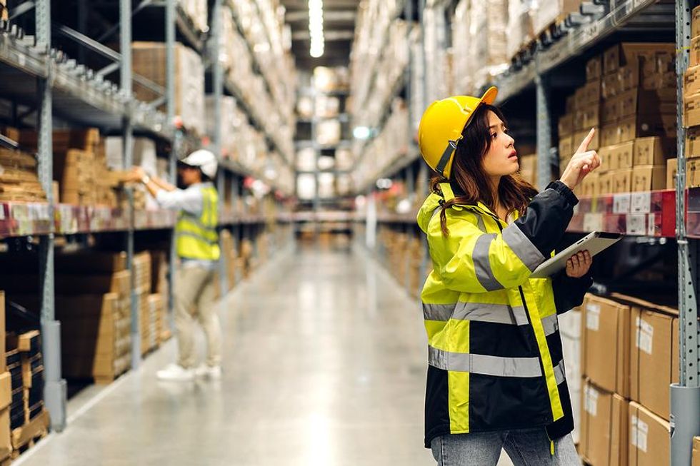 Engineer looks at inventory on shelves