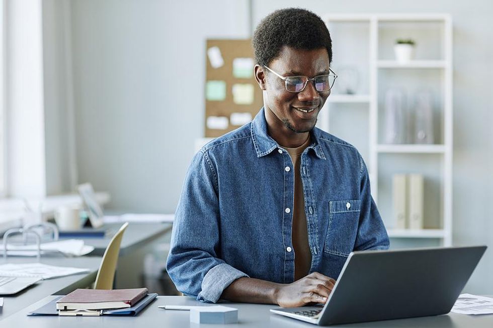 Engineer types on his laptop