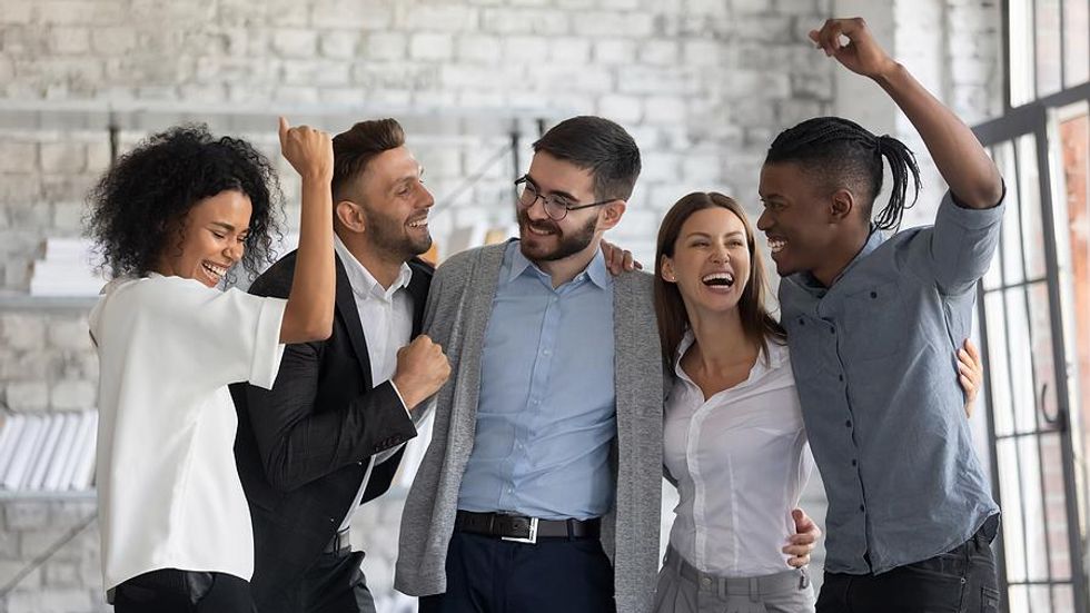 Excited employees celebrate at work