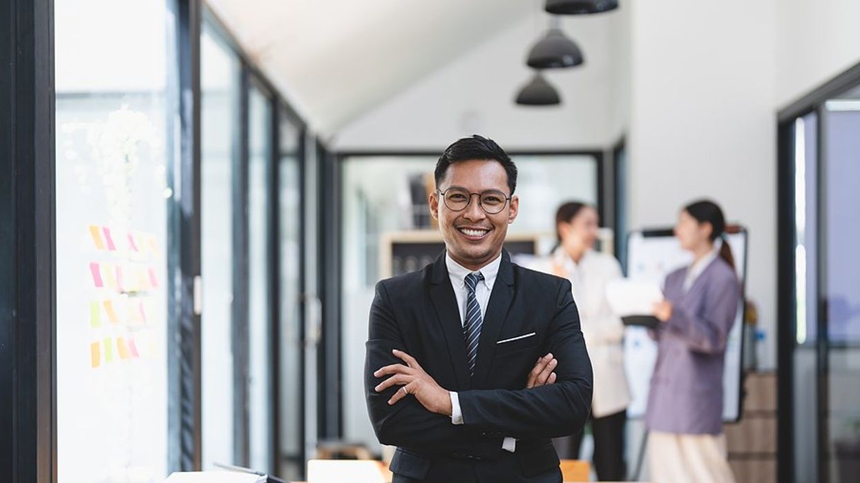 Executive / leader with a good LinkedIn executive presence smiles at work