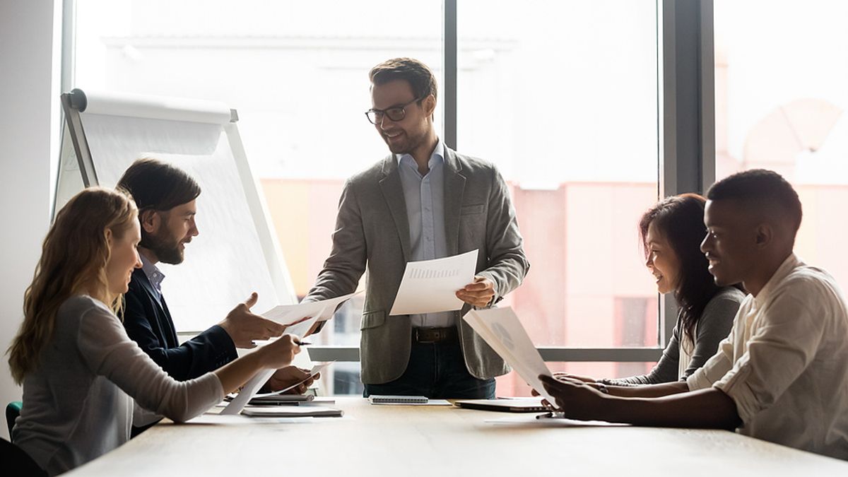 Executive meets with his colleagues during COVID-19
