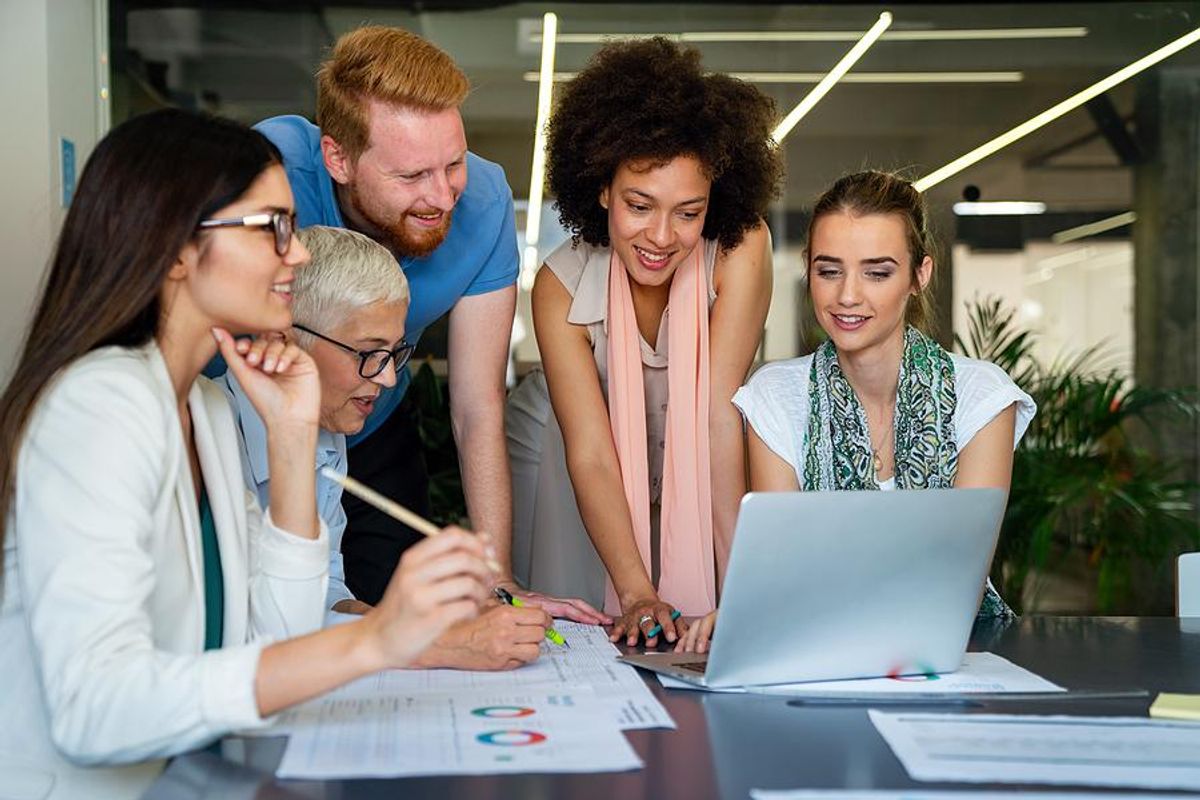 Executive sits down with her employees during a team meeting