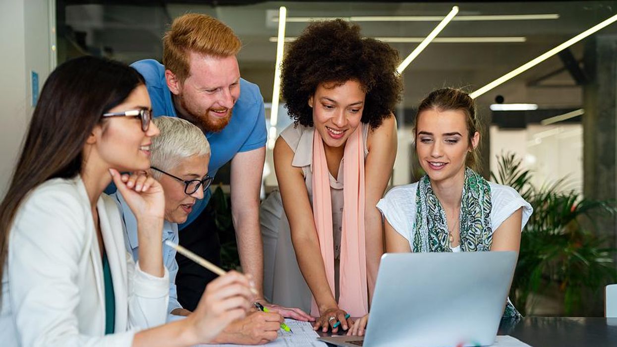 Executive sits down with her employees during a team meeting