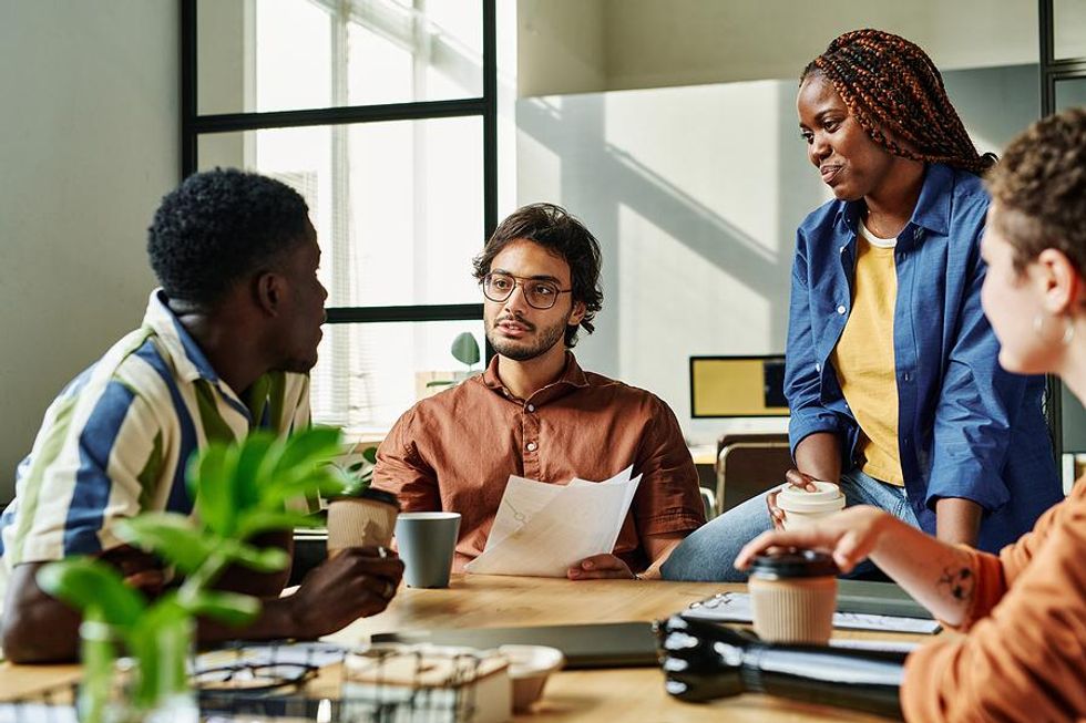 Executive talks to her employees during a team meeting