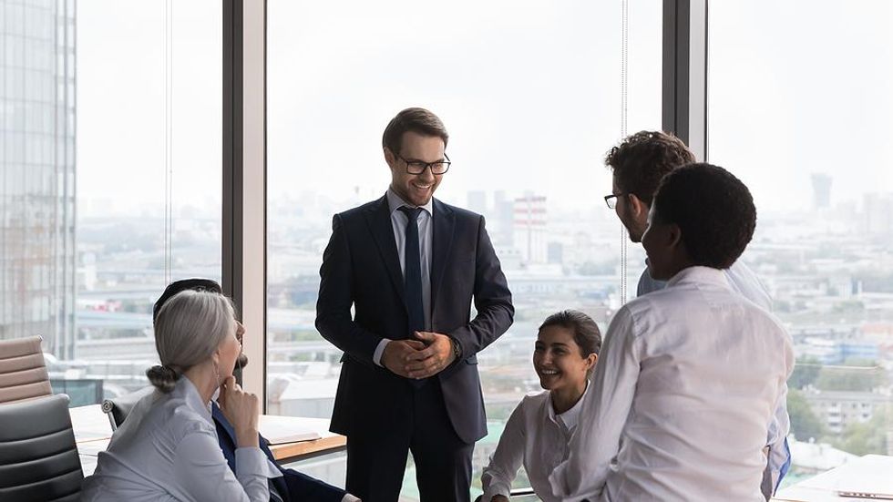 Executive talks to his employees during a work meeting