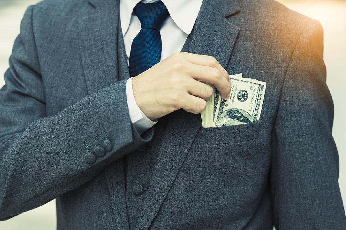 Executive with money in his pocket