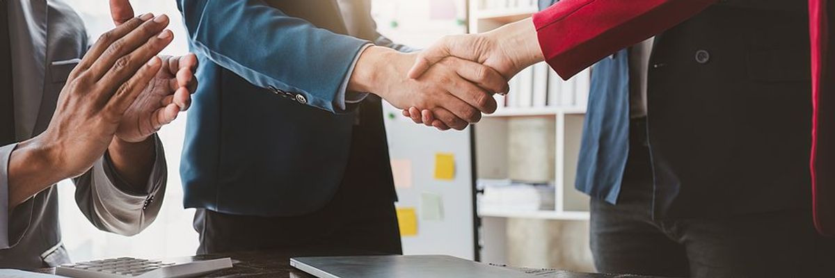 Executives/business professionals shake hands