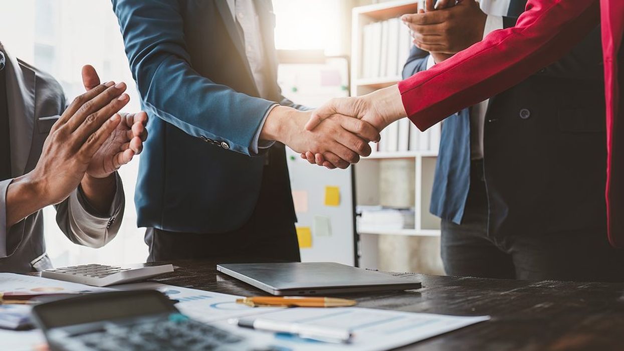 Executives/business professionals shake hands