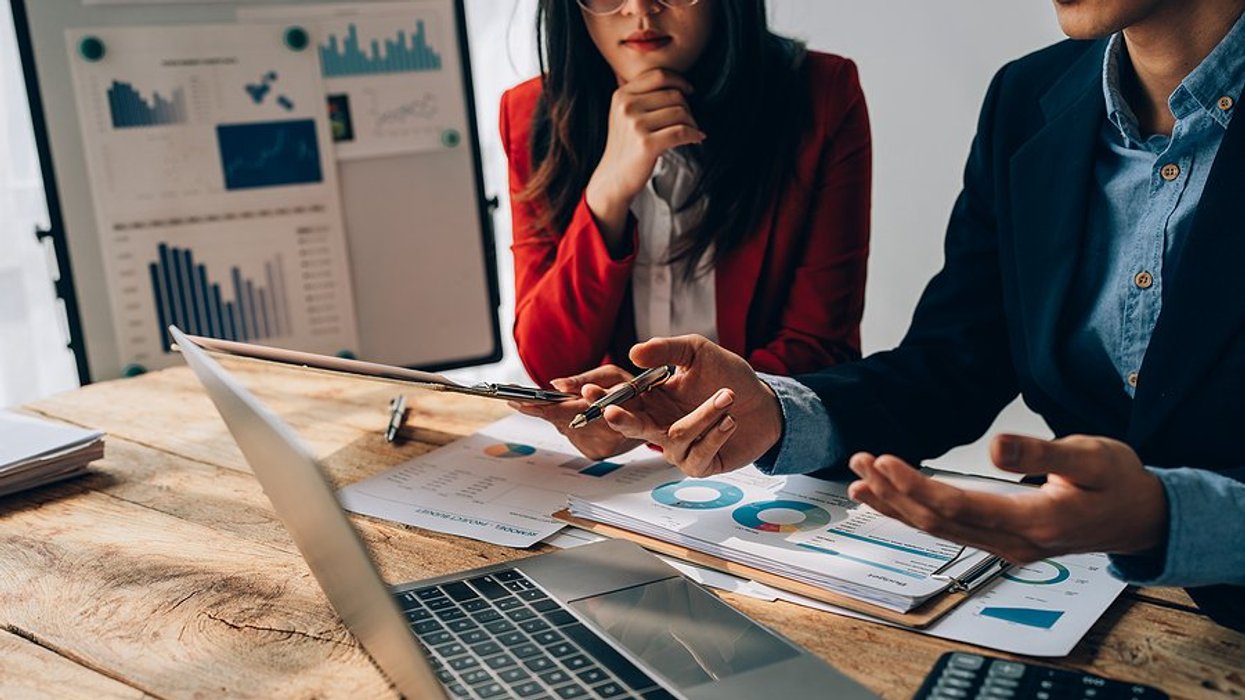 Executives/leaders in a meeting discuss business sustainability and planning