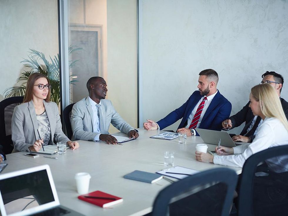 Executives talk to board of directors in a meeting