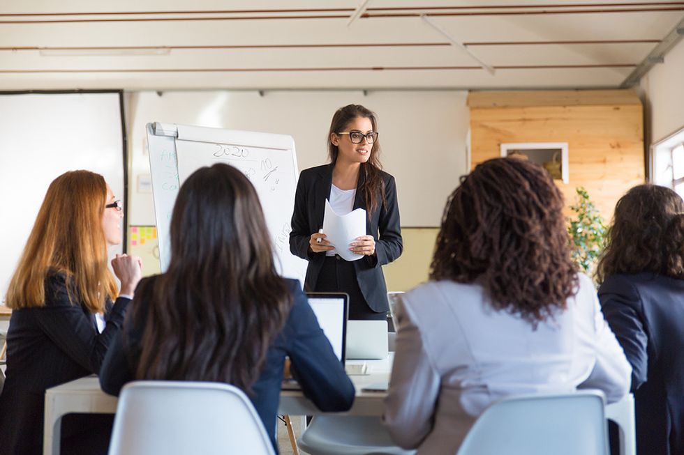 Female executive/leader communicates with her team during a crisis