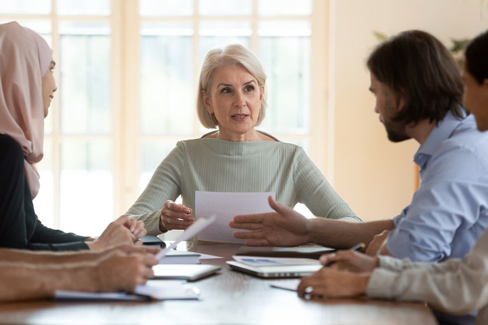 Female executive leads a meeting after successfully changing careers