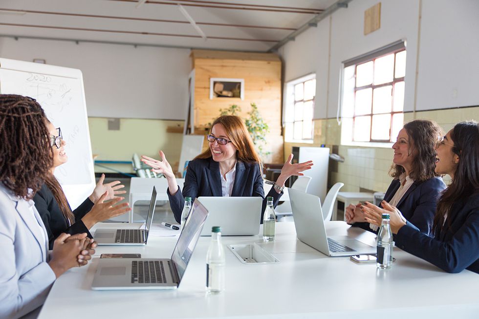 Female executives discuss motivation during a meeting