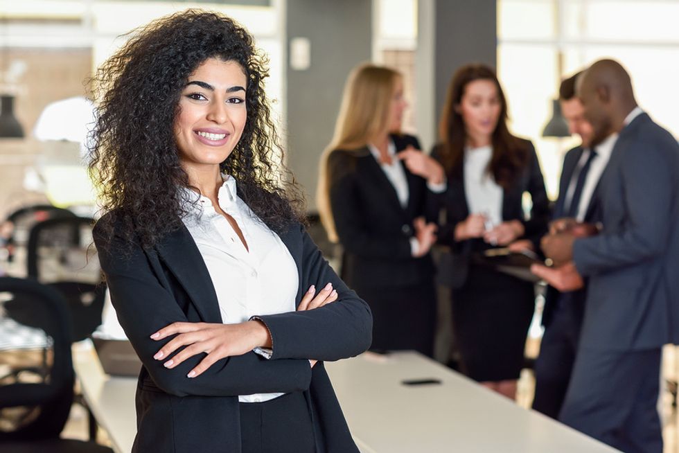 Female leader improving her leadership skills and getting promoted at work.