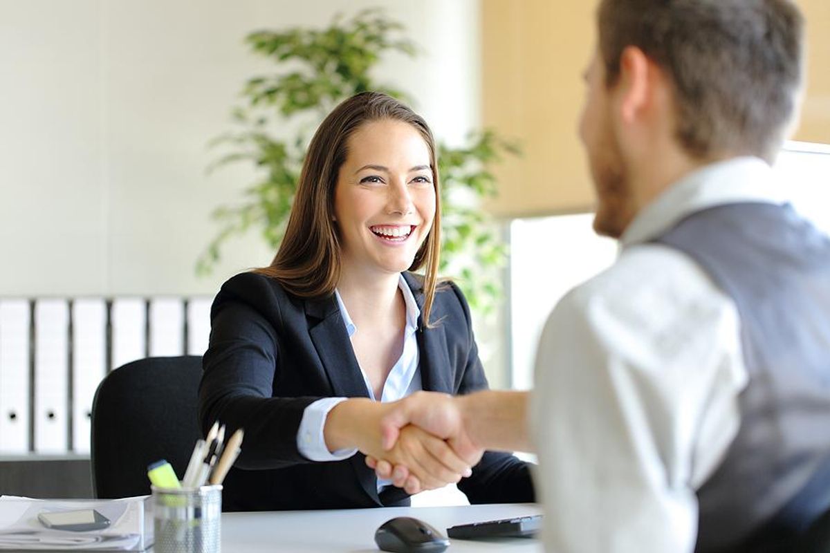 Female salesperson closes a deal with a client