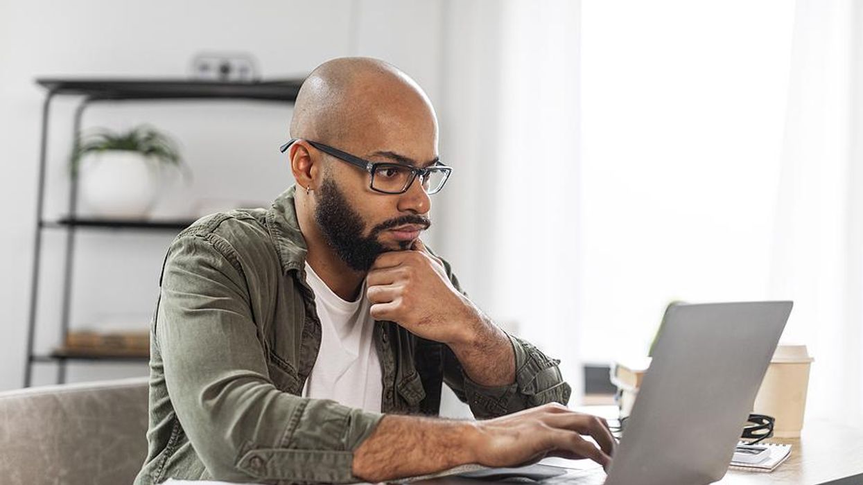 Focused man on a laptop looks for a job