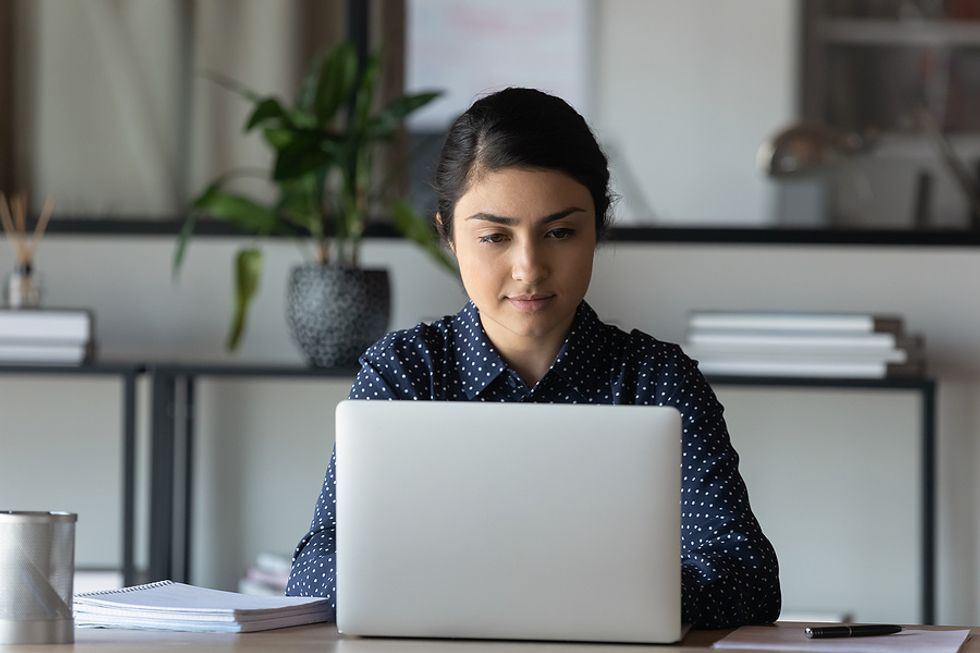 Focused professional puts some time and effort into her LinkedIn profile.