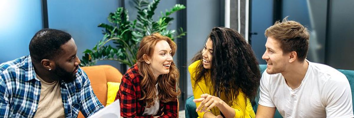 Friendly coworkers talk during a meeting
