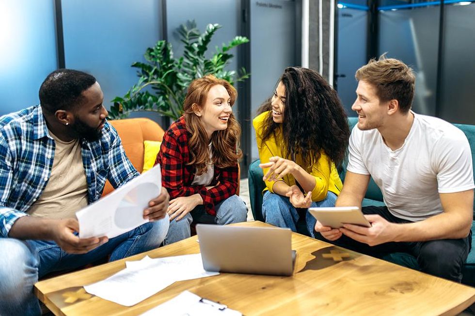 Friendly coworkers talk during a meeting