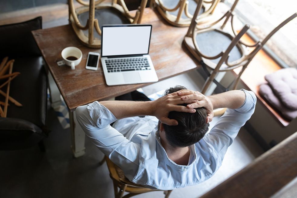 Frustrated man on laptop doesn't feel confident in his job search