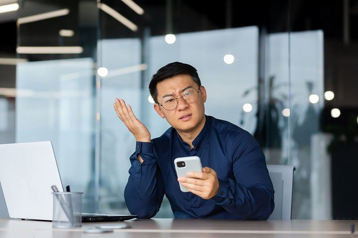 Frustrated man on phone wonders why people are ignoring his LinkedIn connection requests