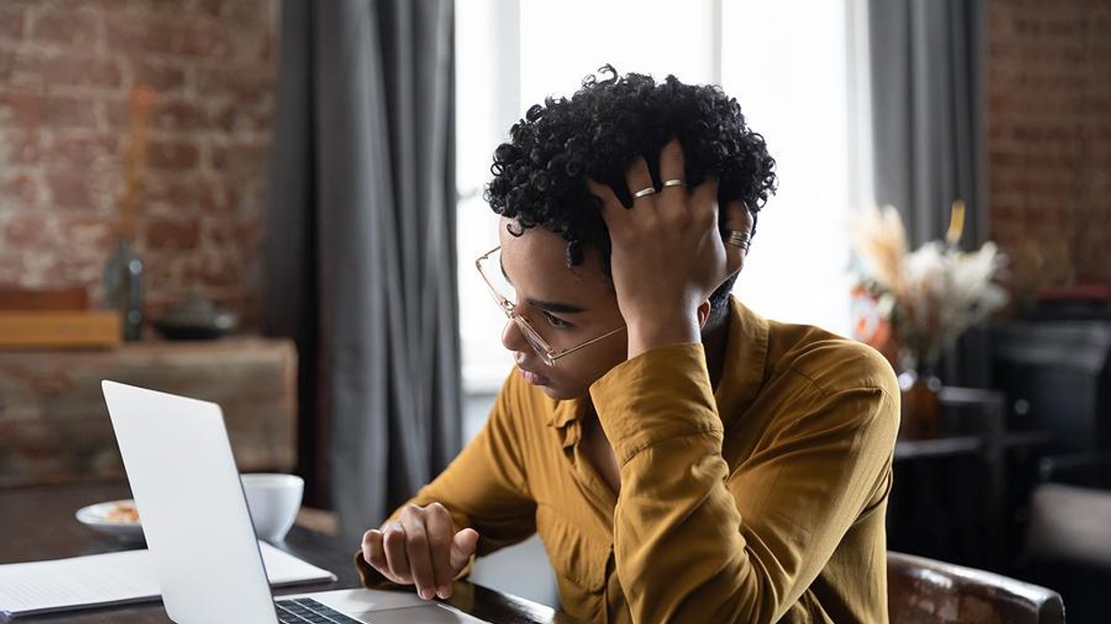 Frustrated/stressed unemployed woman on laptop looks for a job