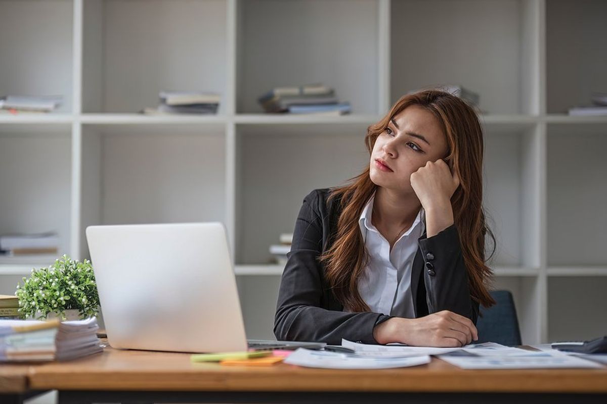 Frustrated/stressed woman wonders why she hasn't been promoted at work