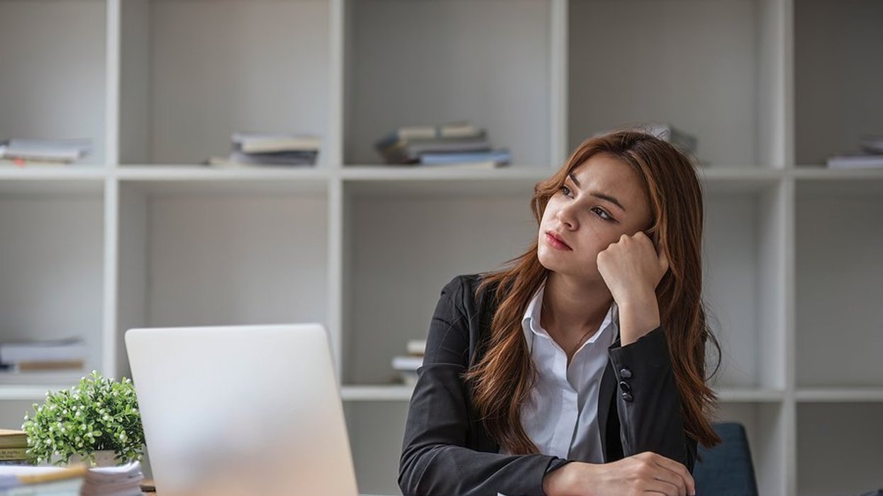 Frustrated/stressed woman wonders why she hasn't been promoted at work