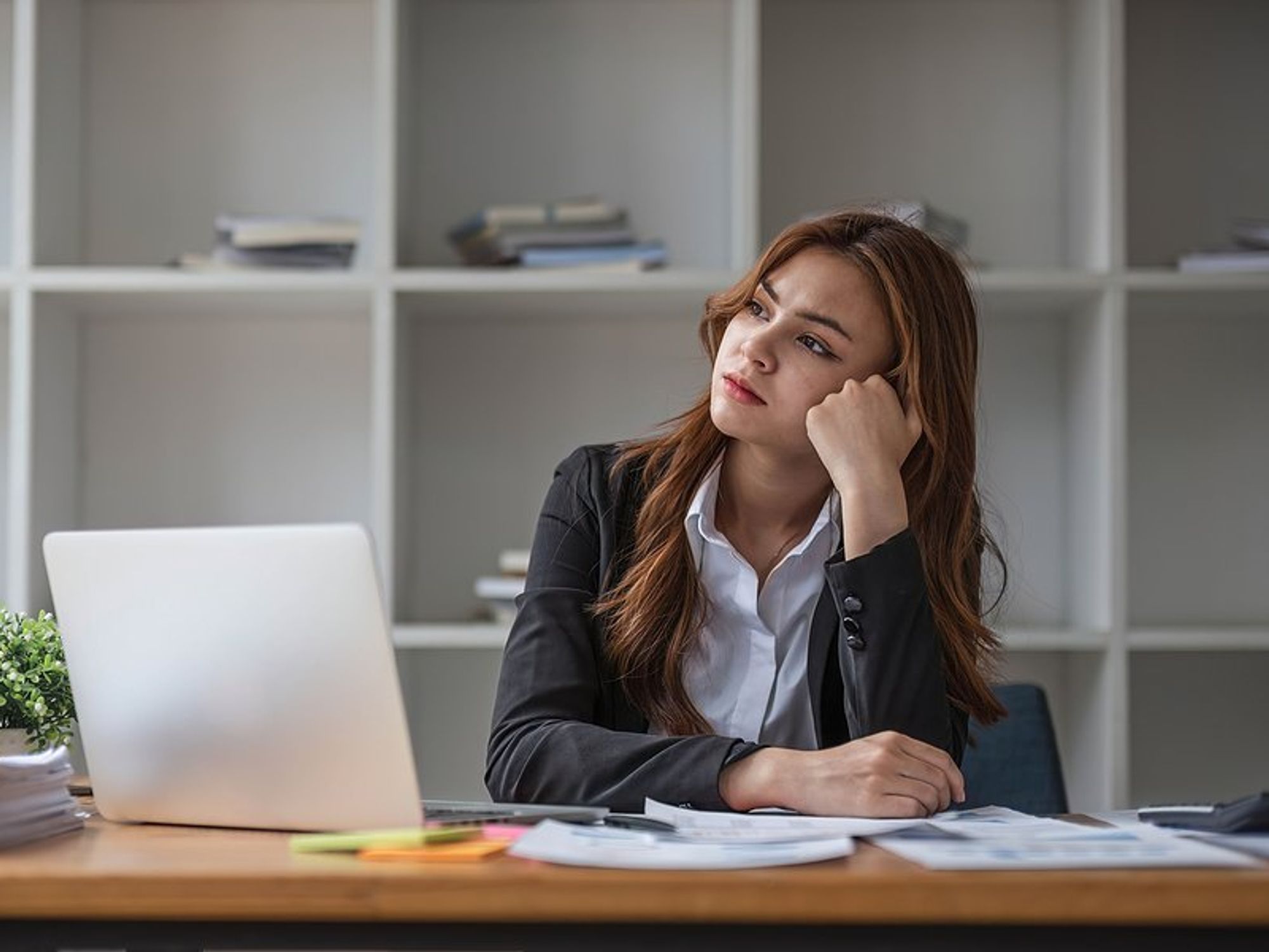 Frustrated/stressed woman wonders why she hasn't been promoted at work