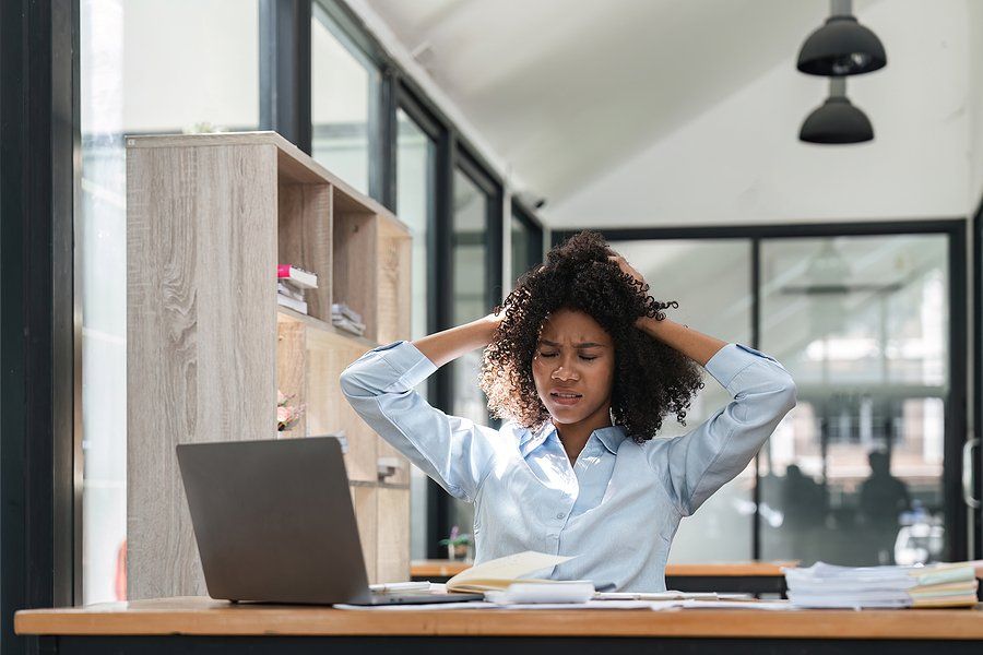Frustrated woman at work wonders if she should look for a new job