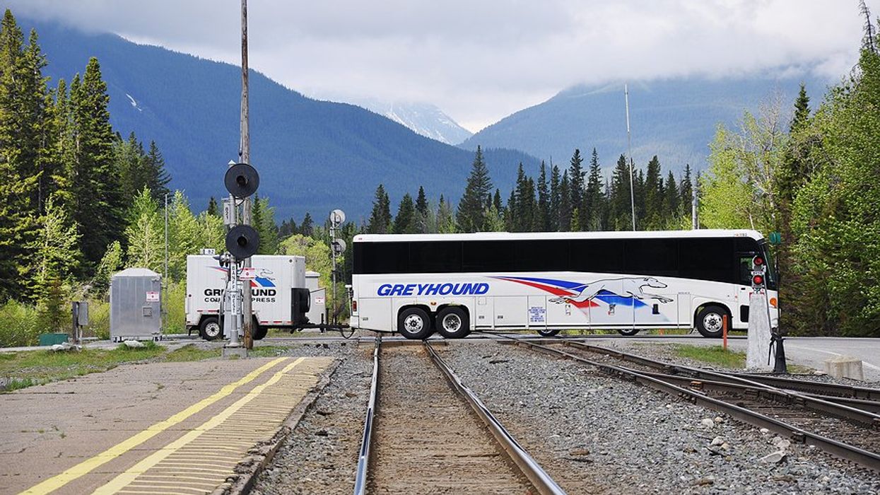 Greyhound bus crosses train tracks in Banff, Canada