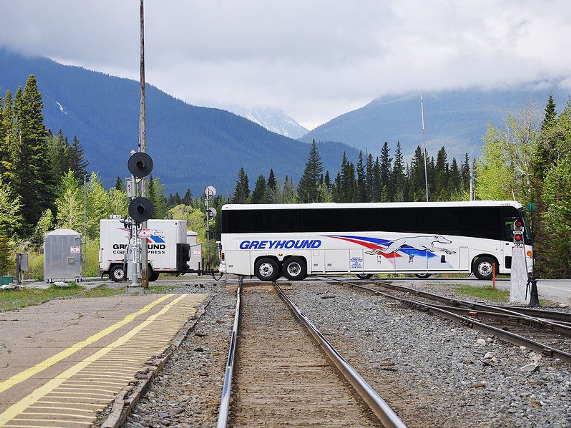 Greyhound bus crosses train tracks in Banff, Canada