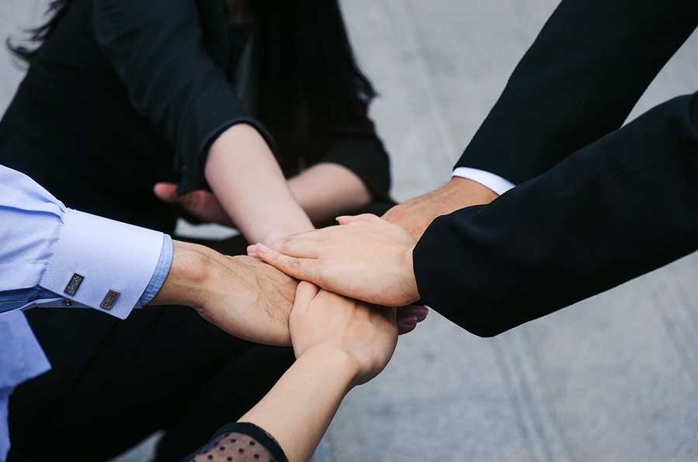 Group of business people team joining hands together in the community, connection concept