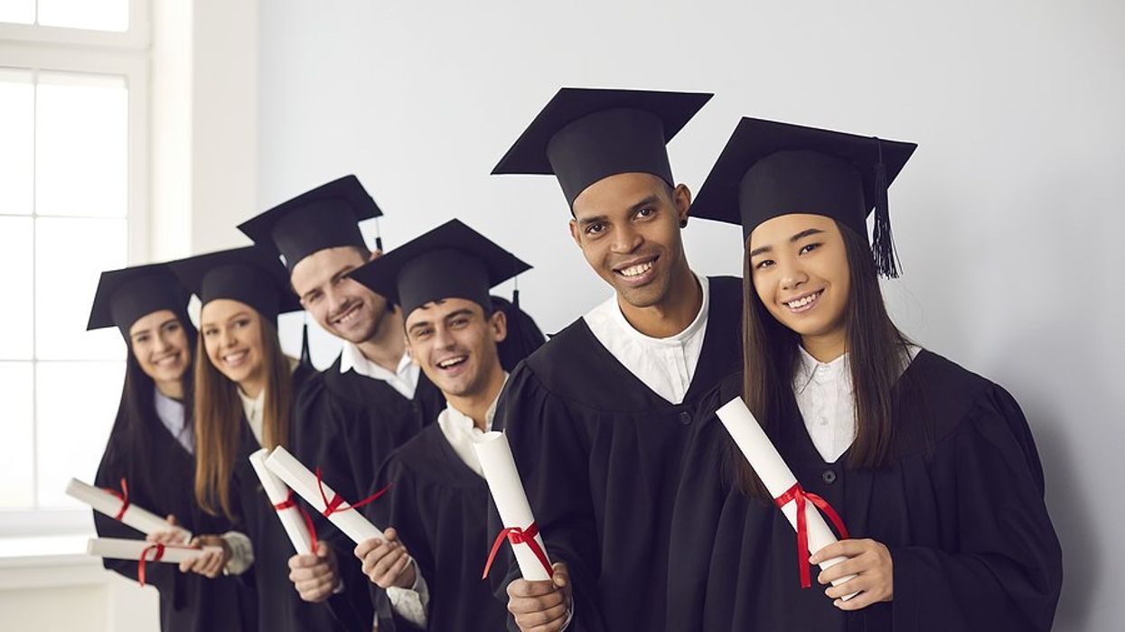 Group of college grads holding their diplomas