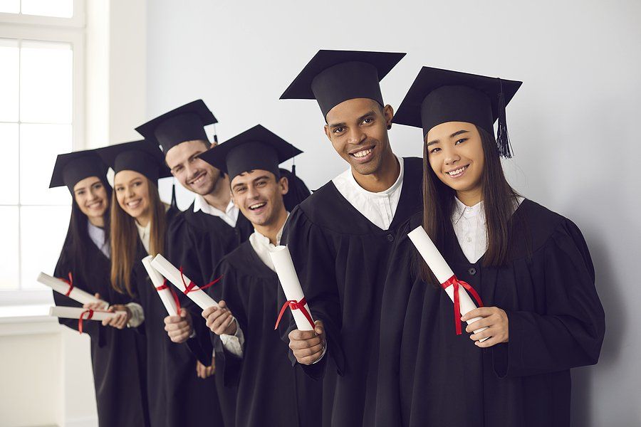 Group of college grads holding their diplomas