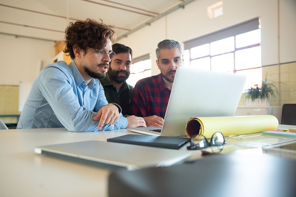 Group of coworkers discuss industry trends